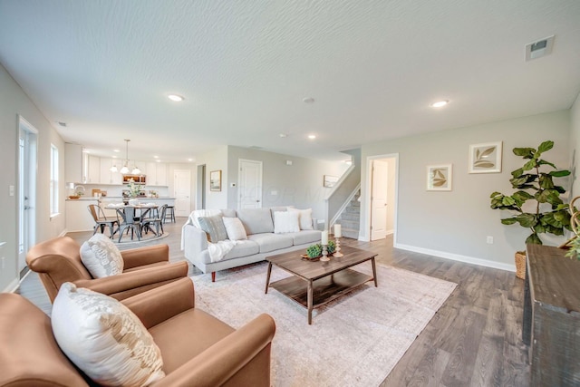 66 Genoa Cir, Commercial Point, OH 43116 - living area with dark wood finished floors, stairs, and recessed lighting