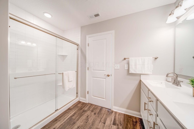 66 Genoa Cir, Commercial Point, OH 43116 - full bathroom with double vanity, a shower stall, and wood finished floors