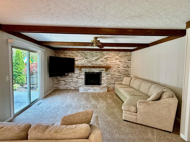 1724 Ramblewood Ave, Columbus, OH 43235 - carpeted living room featuring a ceiling fan, a textured ceiling, beamed ceiling, and a fireplace