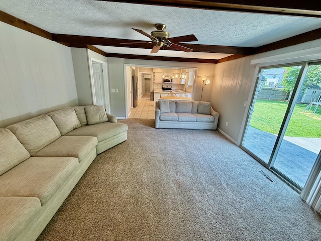 1724 Ramblewood Ave, Columbus, OH 43235 - living room featuring light carpet, a textured ceiling, ceiling fan, wooden walls, and beam ceiling