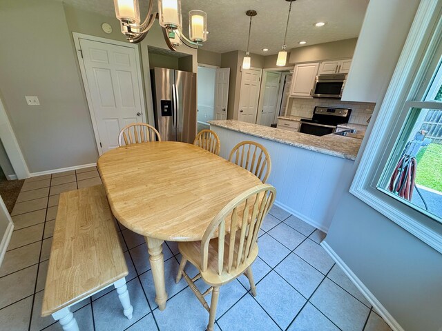 1724 Ramblewood Ave, Columbus, OH 43235 - dining area with light tile patterned flooring, a chandelier, and recessed lighting