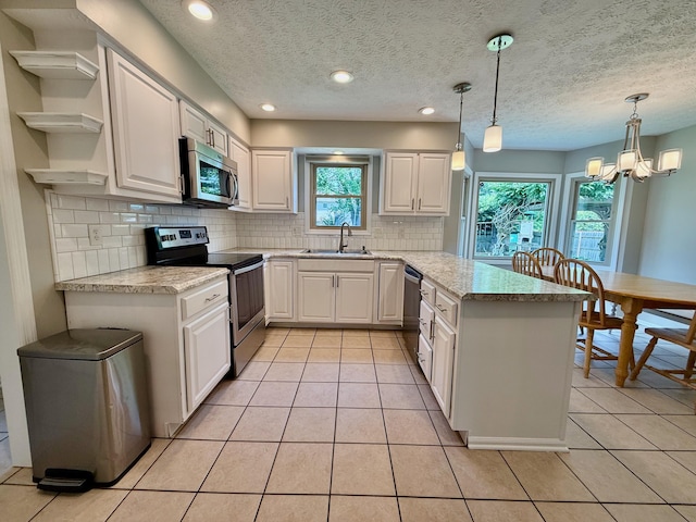1724 Ramblewood Ave, Columbus, OH 43235 - kitchen with stainless steel appliances, a peninsula, open shelves, decorative backsplash, and light tile patterned floors
