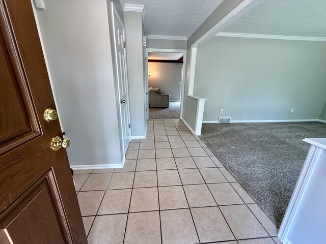 1724 Ramblewood Ave, Columbus, OH 43235 - foyer featuring light carpet, light tile patterned floors, a textured ceiling, and crown molding