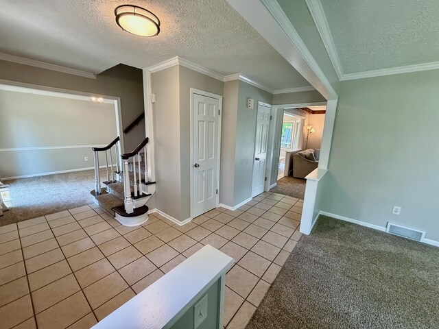 1724 Ramblewood Ave, Columbus, OH 43235 - entrance foyer featuring light colored carpet, a textured ceiling, light tile patterned floors, stairway, and crown molding