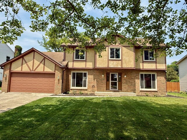 1724 Ramblewood Ave, Columbus, OH 43235 - tudor home featuring stucco siding, a garage, concrete driveway, and brick siding