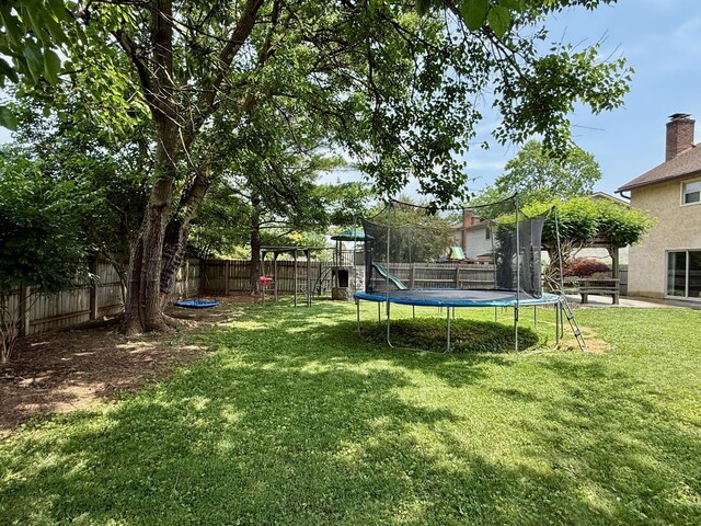 1724 Ramblewood Ave, Columbus, OH 43235 - fenced backyard with a trampoline and a playground