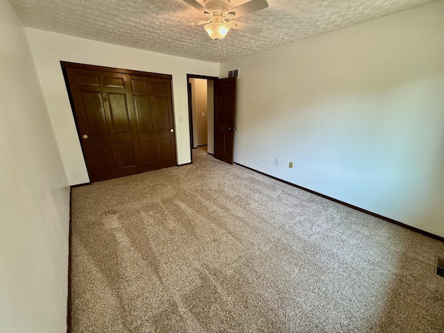1724 Ramblewood Ave, Columbus, OH 43235 - unfurnished bedroom featuring a textured ceiling, a closet, light carpet, and ceiling fan