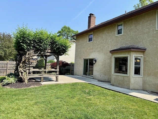 1724 Ramblewood Ave, Columbus, OH 43235 - back of house featuring stucco siding, a patio area, and a chimney