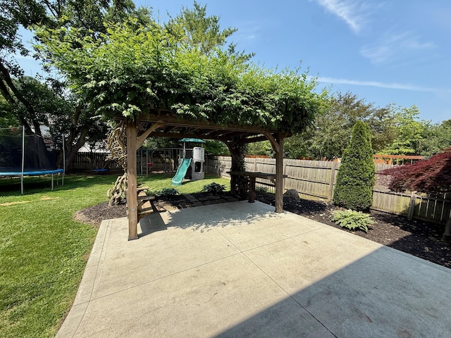 1724 Ramblewood Ave, Columbus, OH 43235 - fenced backyard with a trampoline, a patio area, and a playground