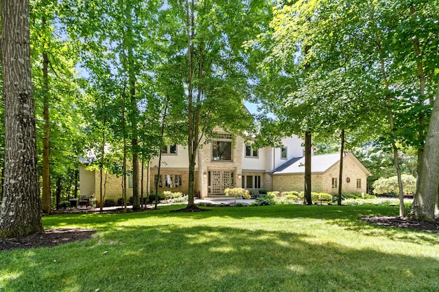 1967 Woodlands Pl, Powell, OH 43065 - view of front of house featuring a front yard, stucco siding, and stone siding