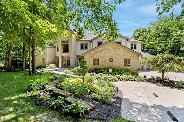 1967 Woodlands Pl, Powell, OH 43065 - view of front of home with stone siding, stucco siding, and a front lawn