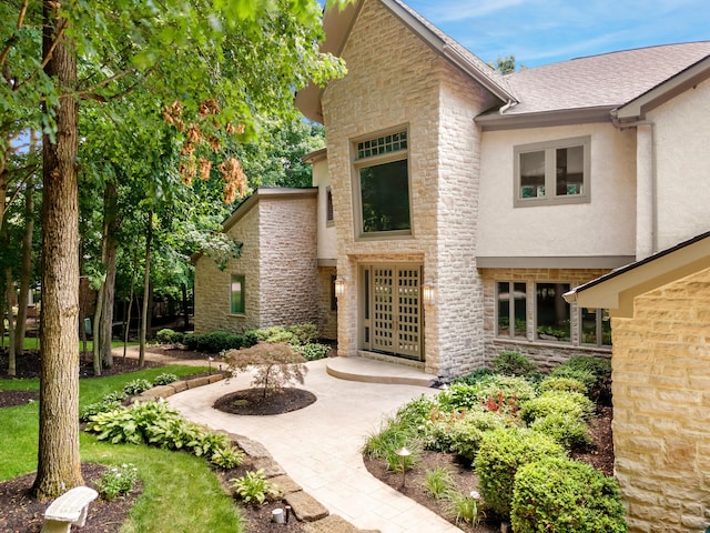 1967 Woodlands Pl, Powell, OH 43065 - doorway to property featuring stone siding and stucco siding