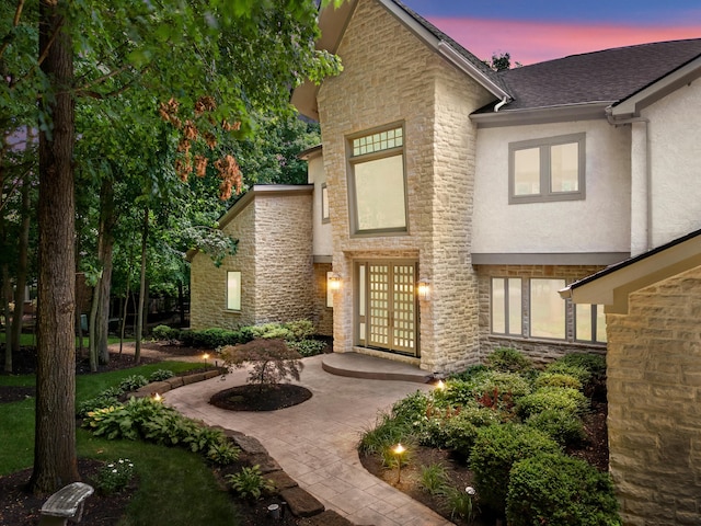 1967 Woodlands Pl, Powell, OH 43065 - view of front facade with stone siding, stucco siding, and roof with shingles