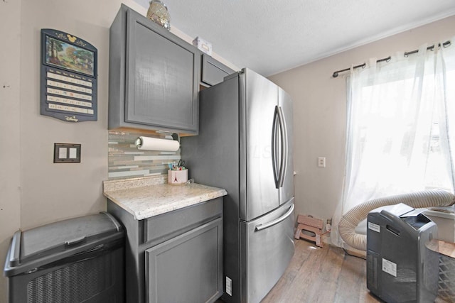 136 Ridgeview Ct, Johnstown, OH 43031 - kitchen featuring freestanding refrigerator, gray cabinets, light wood-style floors, and tasteful backsplash
