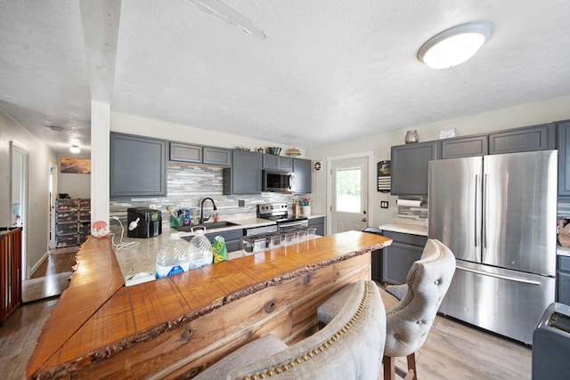 136 Ridgeview Ct, Johnstown, OH 43031 - kitchen with stainless steel appliances, gray cabinetry, light countertops, and a textured ceiling