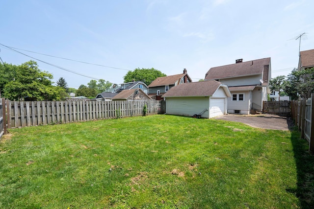 297 Central Ave, Newark, OH 43055 - fenced backyard with an outbuilding, a detached garage, asphalt driveway, and a patio