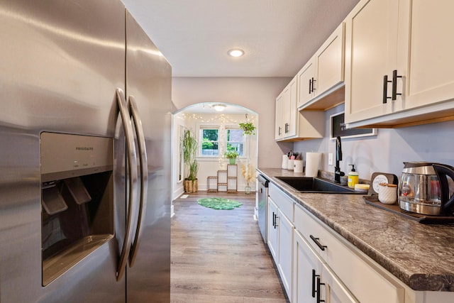 297 Central Ave, Newark, OH 43055 - kitchen featuring stainless steel fridge with ice dispenser, arched walkways, recessed lighting, light wood finished floors, and white cabinetry
