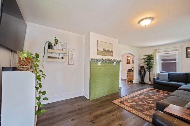 297 Central Ave, Newark, OH 43055 - living room featuring arched walkways, dark wood finished floors, and a textured ceiling