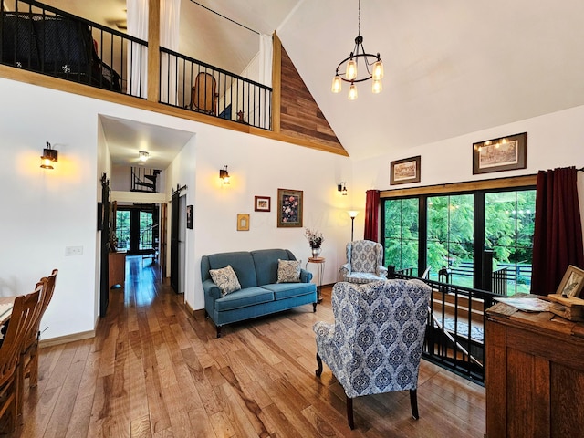 1240 Beath Ln, South Salem, OH 45681 - living room featuring high vaulted ceiling, a chandelier, and hardwood / wood-style flooring