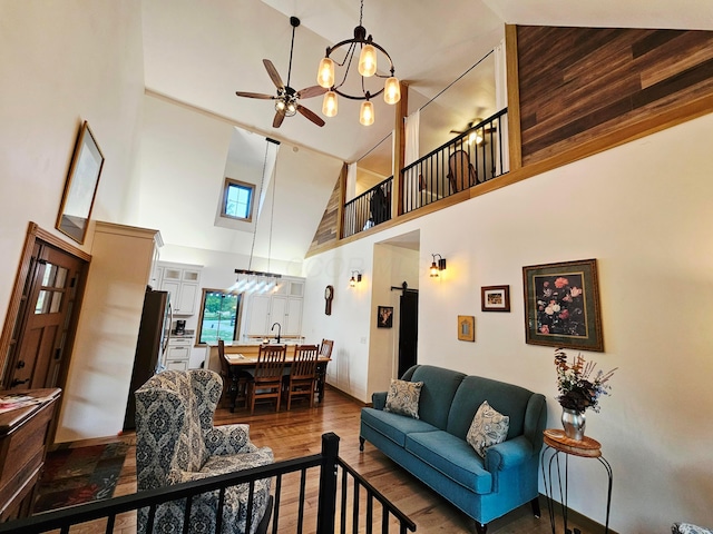 1240 Beath Ln, South Salem, OH 45681 - living area featuring a towering ceiling, ceiling fan, wood finished floors, and a chandelier