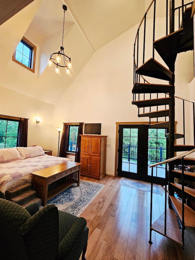 1240 Beath Ln, South Salem, OH 45681 - bedroom with high vaulted ceiling, a chandelier, access to outside, hardwood / wood-style flooring, and french doors