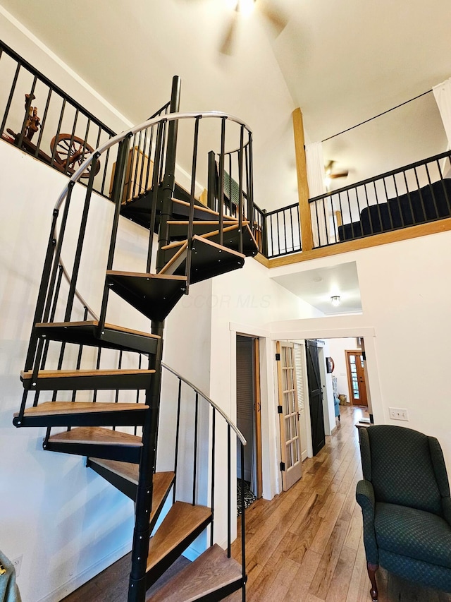 1240 Beath Ln, South Salem, OH 45681 - stairway with wood-type flooring, french doors, and a towering ceiling