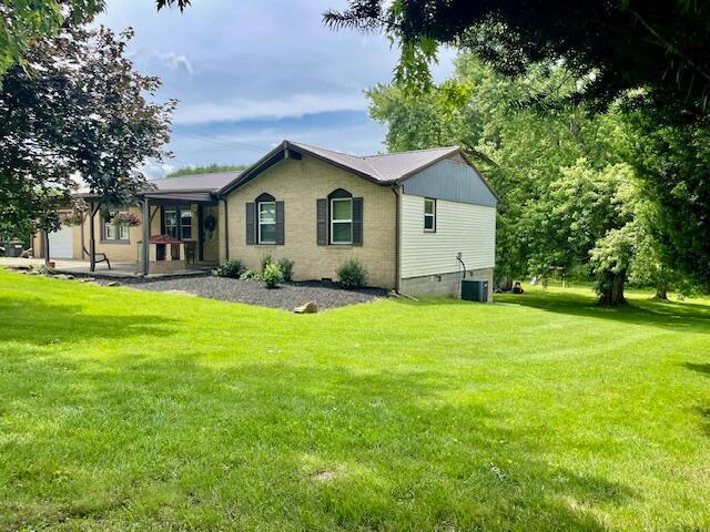 10363 Bremen Rd, Logan, OH 43138 - back of house featuring a lawn and covered porch