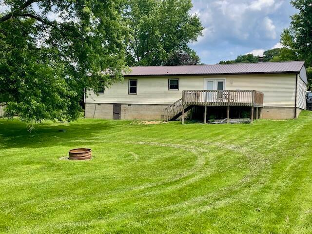 10363 Bremen Rd, Logan, OH 43138 - rear view of house featuring an outdoor fire pit, a deck, stairs, and a lawn