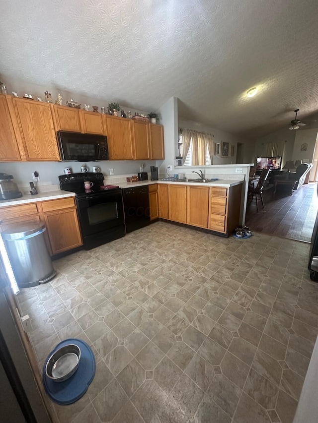 5393 Blanchard Dr, Canal Winchester, OH 43110 - kitchen featuring black appliances, light countertops, open floor plan, a textured ceiling, and a peninsula