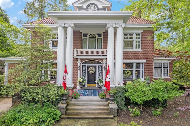 2465 E Broad St, Bexley, OH 43209 - neoclassical / greek revival house with a porch, brick siding, and a tile roof