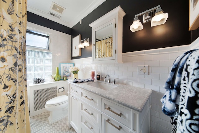 2465 E Broad St, Bexley, OH 43209 - bathroom featuring vanity, ornamental molding, tile patterned floors, and tile walls