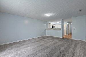 5177 Novelty Ave Unit 72C, Canal Winchester, OH 43110 - unfurnished living room featuring baseboards and carpet flooring