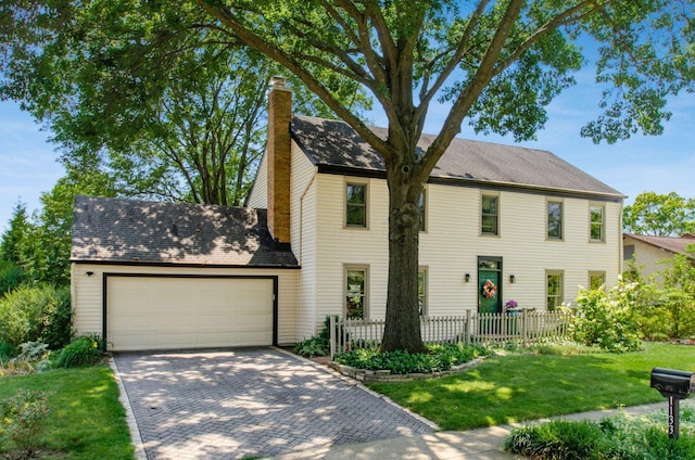 1133 Rockport Ln, Columbus, OH 43235 - colonial-style house with a chimney, an attached garage, driveway, and a shingled roof