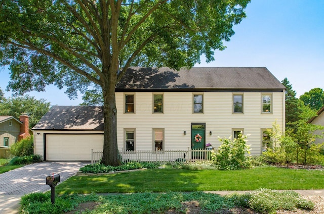 1133 Rockport Ln, Columbus, OH 43235 - colonial-style house featuring a garage, driveway, and a front lawn