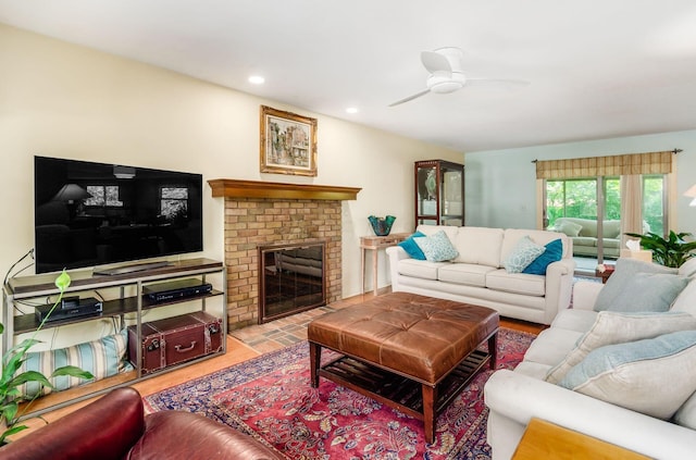 1133 Rockport Ln, Columbus, OH 43235 - living area with wood finished floors, a ceiling fan, a brick fireplace, and recessed lighting