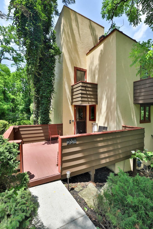 230 E S St, Worthington, OH 43085 - view of property exterior with stucco siding and a wooden deck