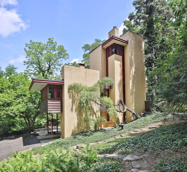 230 E S St, Worthington, OH 43085 - view of side of property with a chimney and stucco siding