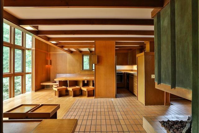 230 E S St, Worthington, OH 43085 - unfurnished living room featuring beam ceiling and light tile patterned floors