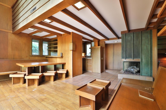 230 E S St, Worthington, OH 43085 - unfurnished living room with wooden walls, beam ceiling, and a large fireplace