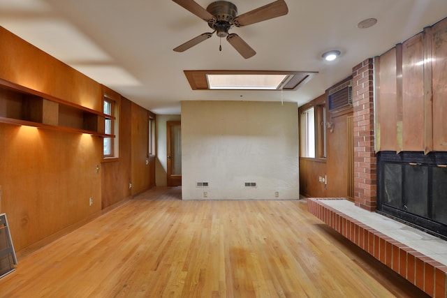 230 E S St, Worthington, OH 43085 - unfurnished living room with a ceiling fan, light wood finished floors, a wall mounted AC, and a skylight