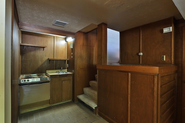 230 E S St, Worthington, OH 43085 - kitchen featuring range with electric stovetop, a textured ceiling, and light tile patterned floors
