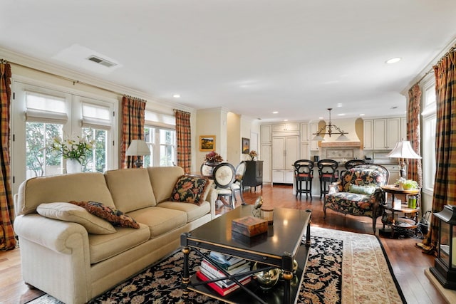 161 Jackson St, Columbus, OH 43206 - living room featuring plenty of natural light, hardwood / wood-style floors, ornamental molding, and recessed lighting