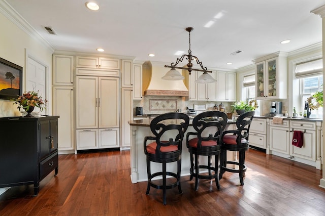 161 Jackson St, Columbus, OH 43206 - kitchen featuring custom exhaust hood, paneled built in refrigerator, crown molding, dark wood-style floors, and tasteful backsplash