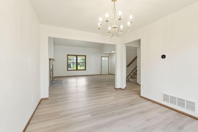 113 Olentangy Meadows Dr, Lewis Center, OH 43035 - unfurnished dining area featuring a chandelier, light wood-style flooring, and stairway