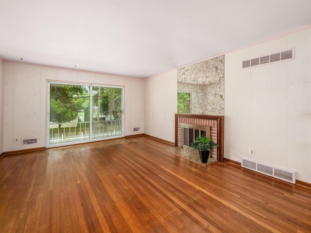 1530 Pemberton Dr, Columbus, OH 43221 - unfurnished living room with healthy amount of natural light, a fireplace, and wood finished floors