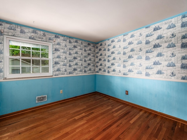 1530 Pemberton Dr, Columbus, OH 43221 - spare room with wood finished floors, wainscoting, and wallpapered walls