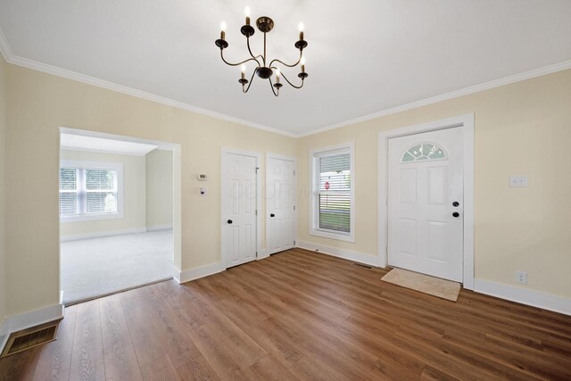 11 E Main St, Sparta, OH 43350 - entryway featuring wood finished floors, a chandelier, and crown molding