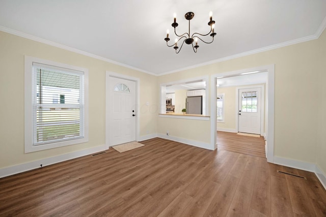 11 E Main St, Sparta, OH 43350 - entrance foyer featuring a chandelier, ornamental molding, and wood finished floors