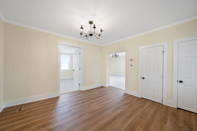 11 E Main St, Sparta, OH 43350 - unfurnished dining area with a chandelier, wood finished floors, and ornamental molding