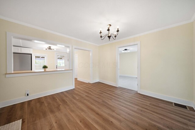 11 E Main St, Sparta, OH 43350 - unfurnished living room featuring a chandelier, wood finished floors, and ornamental molding